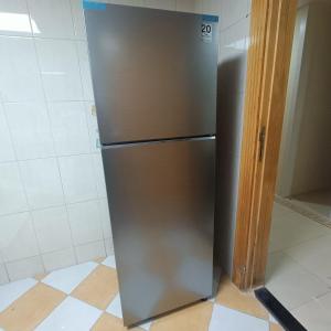 a stainless steel refrigerator sitting in a kitchen at Al Basam Center in Dubai