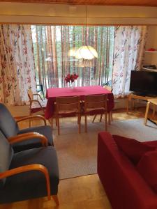 een woonkamer met een tafel met een paars tafelkleed bij Rokua Ahveroinen A3 in Rokua
