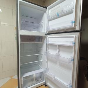an empty refrigerator with its door open in a kitchen at Al Basam Center in Dubai