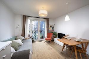 a living room with a couch and a table at Lovely one bedroom apartment in Elephant Castle in London