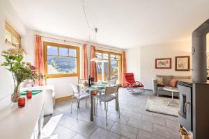 a kitchen and living room with a table and chairs at Trü-Sura Nr. 7 in Scuol