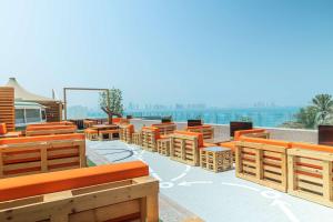 einer Gruppe von Holzbänken und einem Basketballplatz in der Unterkunft Hilton Doha in Doha