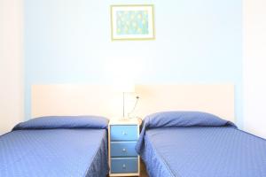 A bed or beds in a room at LITORAL COSTA DORADA - LAS CUMBRES Only families