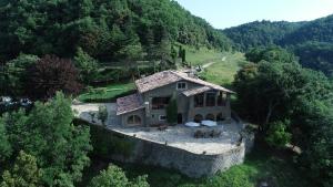 an aerial view of a house in the mountains at Masia Santa Llúcia in Rupit