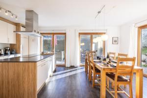 a kitchen and dining room with a table and chairs at Pütvia 245F in Scuol
