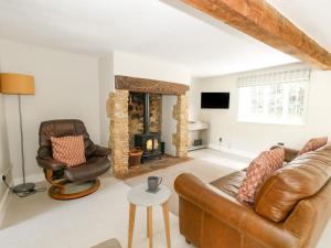 a living room with a couch and a fireplace at Wayside in Beaminster