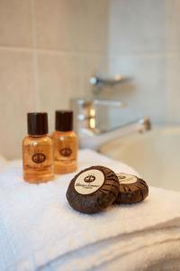 two bottles of soap sitting on top of a towel at Hotel Dei Camosci in Courmayeur