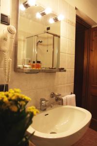 a bathroom with a white sink and a mirror at Hotel Dei Camosci in Courmayeur +37 photos
