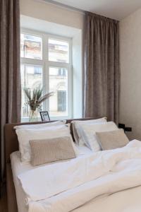 two white beds in a bedroom with a window at Romari Vip Дорошенка 13 in Lviv