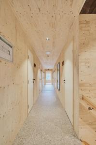 a hallway with wood paneled walls and a long corridor at Lodgen Stryn in Stryn