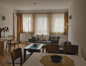 a living room with a couch and a table at Appartement Bürgerbräu Hermagor in Hermagor