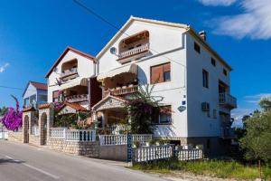 a large white building on the side of a street at Villa Bosotina Royal Sea View in Kukljica