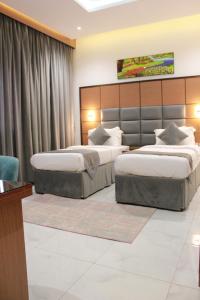a hotel room with two beds in a room at Five Season Hotel in Al Khobar