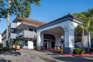 a large white building with an arch entrance at Days Inn by Wyndham Encinitas Moonlight Beach in Encinitas