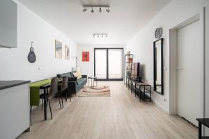 a living room with a couch and a table at Royal Wilanów Comfort Apartment in Warsaw