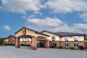 a hotel with a sign on the front of it at Super 8 by Wyndham Cornwall ON in Cornwall