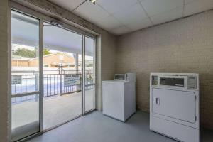 an empty room with a refrigerator and a window at Days Inn by Wyndham Lincolnton in Lincolnton