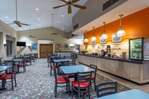 a restaurant with tables and chairs and a bar at Howard Johnson by Wyndham Salem Hotel & Conference Center in Salem