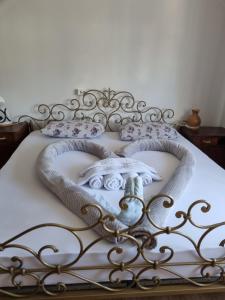 a bed with a white blanket and pillows on it at Vila Antik in Ilirska Bistrica