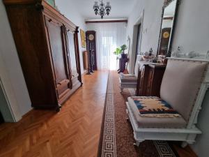 a hallway with chairs and a table in a room at Vila Antik in Ilirska Bistrica