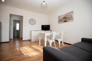 una sala de estar blanca con mesa y sillas en Appartamento Patrizia en Altavilla Vicentina
