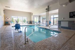 a swimming pool with a chair in a building at Hampton Inn Durango in Durango
