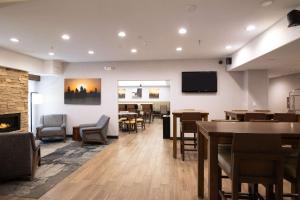 a restaurant with tables and chairs and a fireplace at Hampton Inn Durango in Durango