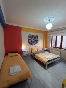 a bedroom with two beds and a painting on the wall at Deeps Hostel Eskişehir in Eskisehir