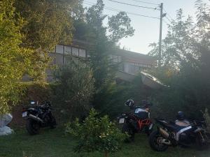 two motorcycles parked in the yard of a house at Guesthouse P&A in Budva