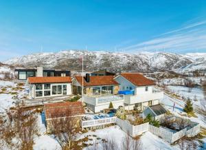 an aerial view of a house in the snow at Brensholmen Beach House in Tromsø