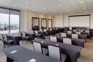 a conference room with tables and chairs and a whiteboard at H Hotel Los Angeles, Curio Collection By Hilton in Los Angeles