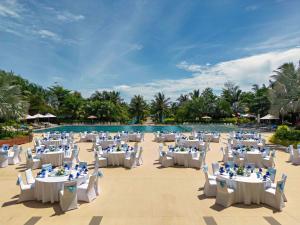 a wedding venue with tables and chairs in front of a pool at Best Western Premier Sonasea Phu Quoc in Phú Quốc