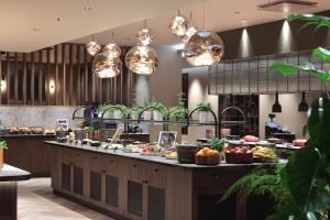 a kitchen with a counter with food on it at Radisson Blu Hotel Lietuva in Vilnius
