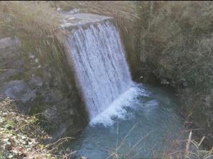 a waterfall on the side of a river at Villa - Malibu' in Lauria Inferiore