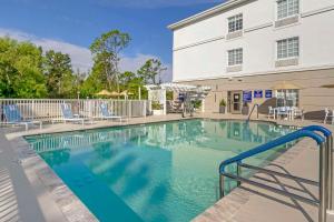 a swimming pool in front of a building at Comfort Inn & Suites Port Charlotte-Punta Gorda in Port Charlotte
