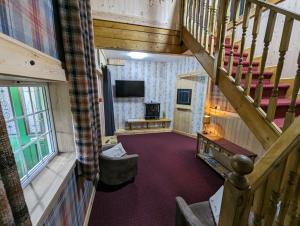 an overhead view of a living room with a staircase at The Steading Highland Glen Lodge in Drumnadrochit
