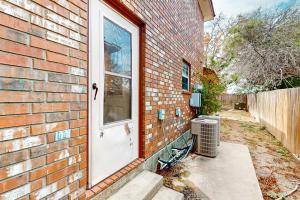 a brick house with a white door and a window at Killeen Serene in Killeen