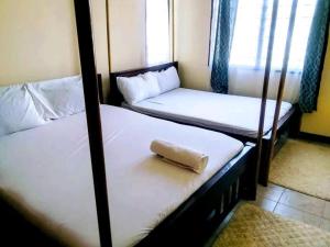 two bunk beds in a room with a window at Vera comfort in Mombasa
