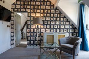 a living room with a wall of plates at Moor Hall Hotel, BW Premier Collection in Sutton Coldfield