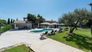 an image of a backyard with a swimming pool at Villa Marijanin Vrt by Villas Holiday in Tinjan