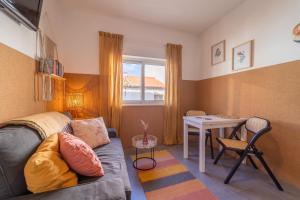 a living room with a couch and a table at Villaceixe - cute living in Odeceixe in Odeceixe