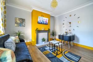 a living room with a couch and a table at *1ES* For your most relaxed & Cosy stay + Free Parking + Free Fast WiFi * in Leeds