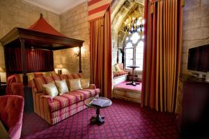 a living room filled with furniture and a red carpet at Langley Castle Hotel in Allendale Town