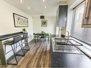 a kitchen and living room with a counter and a table at Southdown Road close to Plymouth Argyle FC in Plymouth
