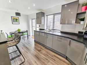 a kitchen with stainless steel appliances and a dining room at Southdown Road close to Plymouth Argyle FC in Plymouth