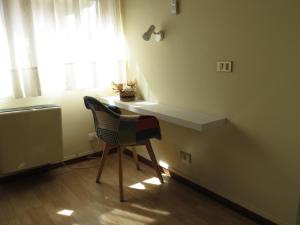 a chair sitting at a desk in a room with a window at Hotel San Michele in Aprilia