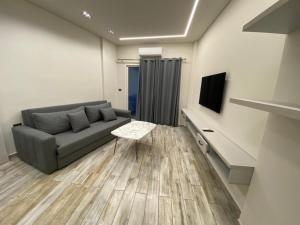 a living room with a couch and a tv at Stunning Sea Front Chalet In Tripoli in Trâblous