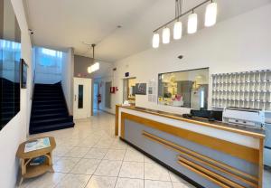 a lobby of a store with a counter and stairs at Hotel Myriam in Lignano Sabbiadoro