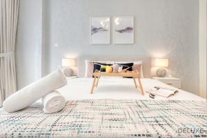 a bedroom with a bed with a table on it at Serene 1BR at Park Terrace Silicon Oasis by Deluxe Holiday Homes in Dubai