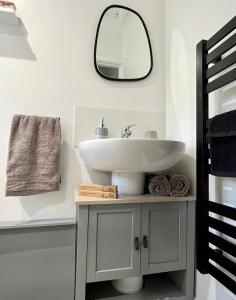 ein Badezimmer mit Waschbecken und Spiegel an der Wand in der Unterkunft Cosy Nook Cottage Perfect Family & Beach Getaway in Newquay + 35 Fotos